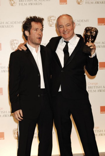 Barry Ackroyd hugs in The Loop's Tom Hollander after winning best Cinematography award for The Hurt Locker (BAFTA/Richard Kendal).