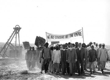 The young Gandhi (Ben Kingsley) leads his first protest march of striking Indian miners in South Africa.