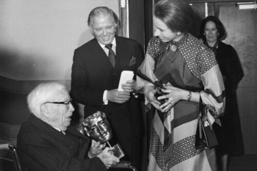 Sir Charles Chaplin recieves the Fellowship award from HRH The Princess Royal at the official Royal Opening of BAFTA's new headquarters at 195 Piccadilly on March 10 1976.
