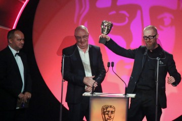 Mark Roalfe, Tomek Baginski and Ron Chakraborty accept the award for Titles & Graphic Identity at the British Academy Television Craft Awards in 2015