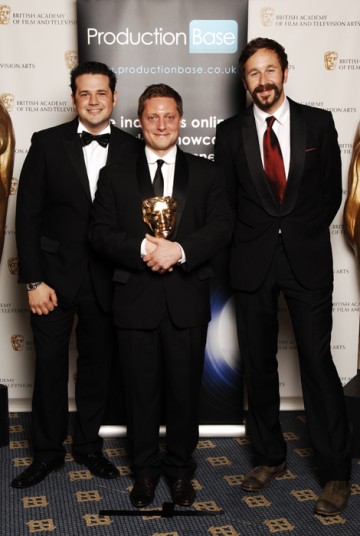 Rowan Joffe (centre) receives the Director Fiction/Entertainment award for The Shooting Of Thomas Hurndall from The IT Crowd star Chris O'Dowd (BAFTA / Richard Kendal).