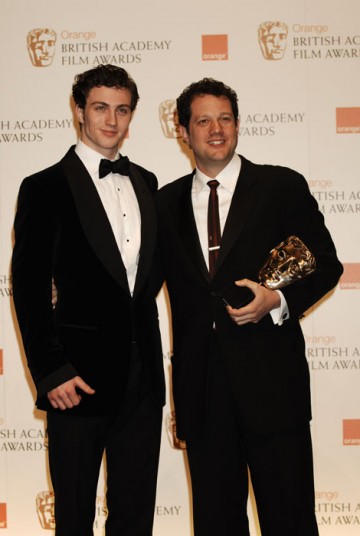 Michael Giacchino, winner of the Music award for his score in UP, stands with Aaron Johnson (BAFTA/Richard Kendal).