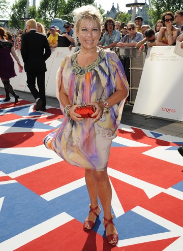 The Shameless and Brookside actress arrives on the union jack carpet.
