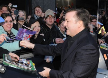 Comedian Ricky Gervais signs autographs for film fans on the red carpet. 
