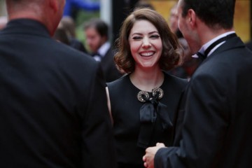 Catherine Steadman, who joined the Downton Abbey cast as Mabel Lane Fox in the show's fifth season, laughs on the red carpet. 