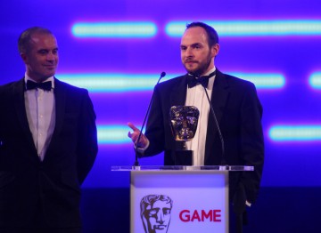 Some of the winning team behind Batman: Arkham City, the game's first award of the night.