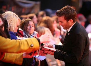 Neill Blomkamp signs for fans on the red carpet. His feature debut, political sci-fi District 9, earned him a Director nomination (BAFTA/Dave Dettman).