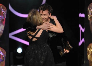 David Tennant congratulates Jane Tranter on stage after presenting her with the Special Award for outstanding creative contribution to the television industry (BAFTA / Marc Hoberman).