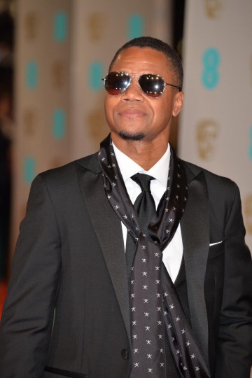 Cuba Gooding Jr. looks super cool in shades and a black print scarf. He is styled by Hackett London.