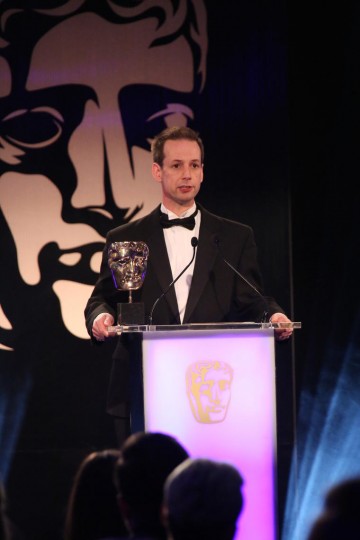 Martin Hollis presents the award for Story at the British Academy Games Awards Ceremony in 2015