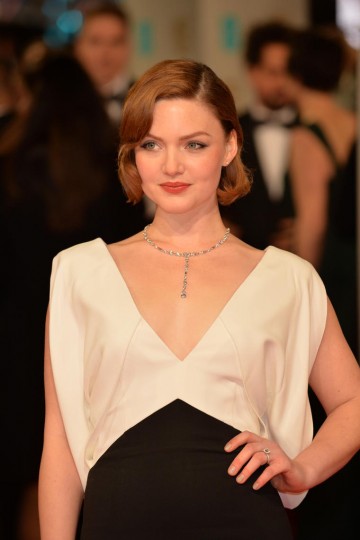 Holliday Grainger looks striking in a black and white V neck dress as she poses on the red carpet