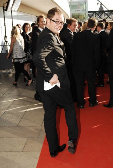 Alan Carr, nominated in the Entertainment Programme for The Friday/Sunday Night Project, strikes a cheeky pose in an Alexander McQueen suit (BAFTA / Richard Kendal).