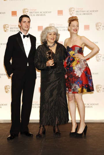 Jenny Shircore poses with her Make Up & Hair award with presenters Matthew Goode and Romola Garai (BAFTA/Richard Kendal).