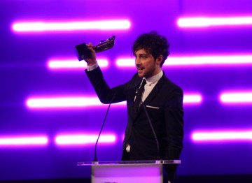 TV Presenter Alex Zane accepts the BAFTA for Debut Game on behalf of the winning team behind Insanely Twisted Shadow Planet.