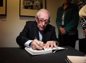 Gilbert signs his memoirs compiled over the course of seven decades working in the film industry.
