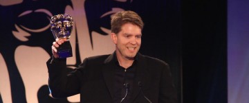 A member of the Destiny development team accepts the award for Best Game at the British Academy Games Awards in 2015
