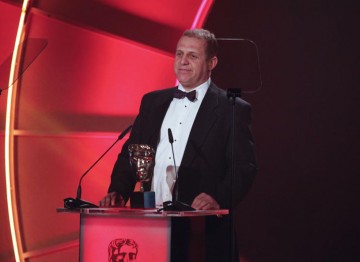 English Actor Nigel Lindsay, perhaps best known for playing the part of Barry in the film Four Lions, presents the Editing: Factual Award. (Pic: BAFTA/Jamie Simonds)