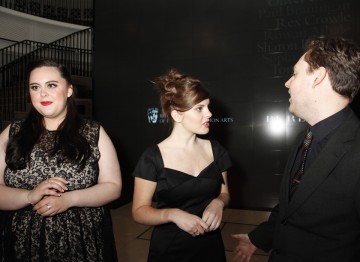Sharon Rooney looks on while Sophia George and Oliver Clarke converse.