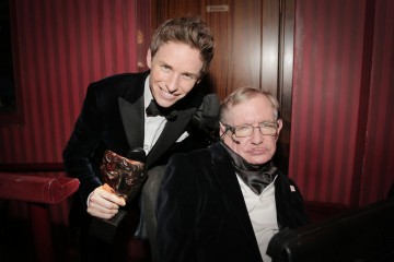 Leading Actor winner Eddie Redmayne poses backstage with Stephen Hawking at London's Royal Opera House.