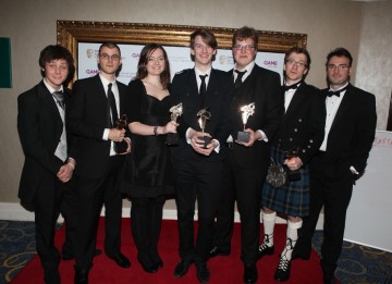 Presenters Tyger Drew-Honey and Jonathan Smith with That Game Studio, aka Jocce Marklund, Annette Nielsen, Linus Nordgren, Marcus Heder, Thomas Finlay, who won for their multiplayer platform racing game, Twang! (Pic: BAFTA/Steve Butler)
