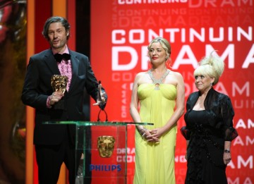 The writing and production team of Eastenders, along with cast members, collect the Continuing Drama Award. (BAFTA/Steve Butler)