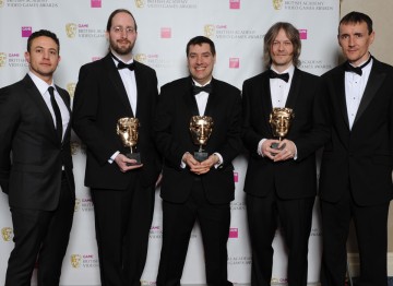 Presenters Warren Brown (l) and Pete Williamson (r) with winners Mark Healey, David Smith and Pete Smith. The jury praised the game’s new editor tools which “takes user generated content from a simple ‘level’ to a full game.”