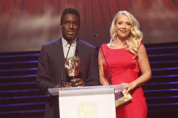 Andy Akinwolere and Laura Hamilton present the BAFTA for Factual at the British Academy Children's Awards in 2014