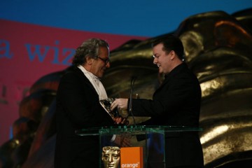 Ricky Gervais (right) presents the BAFTA for Animated Feature Film to George Miller for Happy Feet (BAFTA / Brian Ritchie).