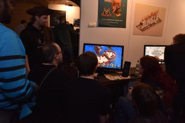 Attendees at the Inside Games Arcade look at a new game