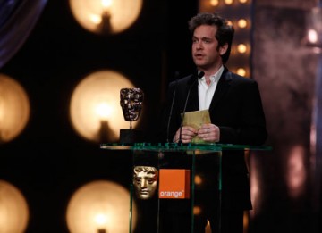 Actor Tom Hollander presents the award for Cinematography (BAFTA/Brian Ritchie).