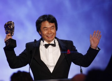 Shigeru Miyamoto celebrates his Academy Fellowship with a cheer on stage at the end of the awards ceremony (BAFTA/Brian Ritchie)