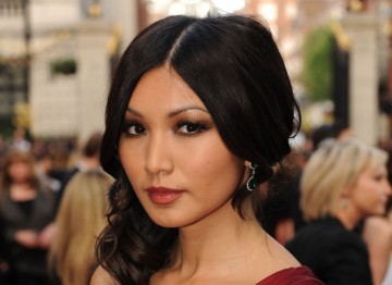 Doctor Who actress Gemma Chan looks beautifully sleek with a sophisticated centre parting, and lightly curled hair draped over one shoulder.