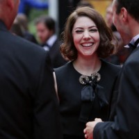 Catherine Steadman, who joined the Downton Abbey cast as Mabel Lane Fox in the show's fifth season, laughs on the red carpet. 