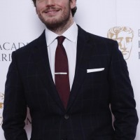Sam Claflin poses for photos after announcing the nominations for the EE British Academy Film Awards in 2015