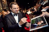 Leonardo DiCaprio signs autographs for fans on the red carpet