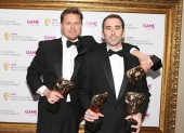 Evan Welles and Christophe Balestra celebrate their four BAFTAs for Uncharted 2: Among Thieves including masks in the Use of Audio, Original Score, Story and Action categories (BAFTA/Steve Butler).