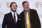 Sam Claflin and Stephen Fry pose for photos after announcing the nominations for the EE British Academy Film Awards in 2015