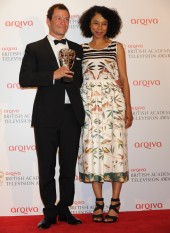 Dominic West celebrates his BAFTA win for Appropriate Adult alongside award presenter Sophie Okonedo.