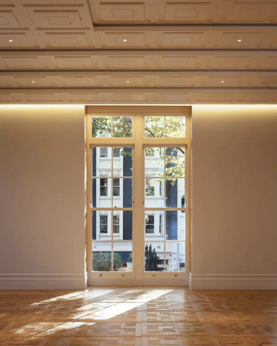 View of the Ray Dolby Room in BAFTA's regenerated headquarters at 195 Piccadilly, London. A large window in a white wall.