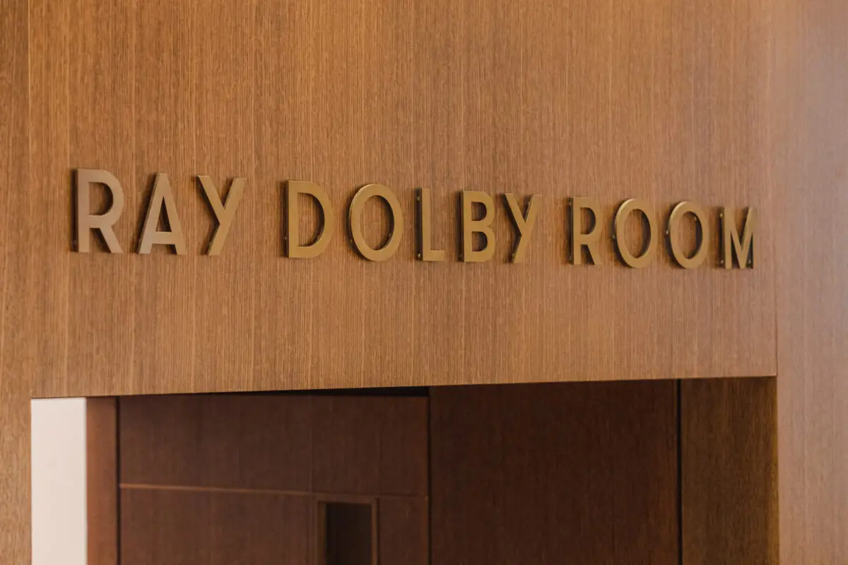 Sign on a wooden wall: Ray Dolby Room.
