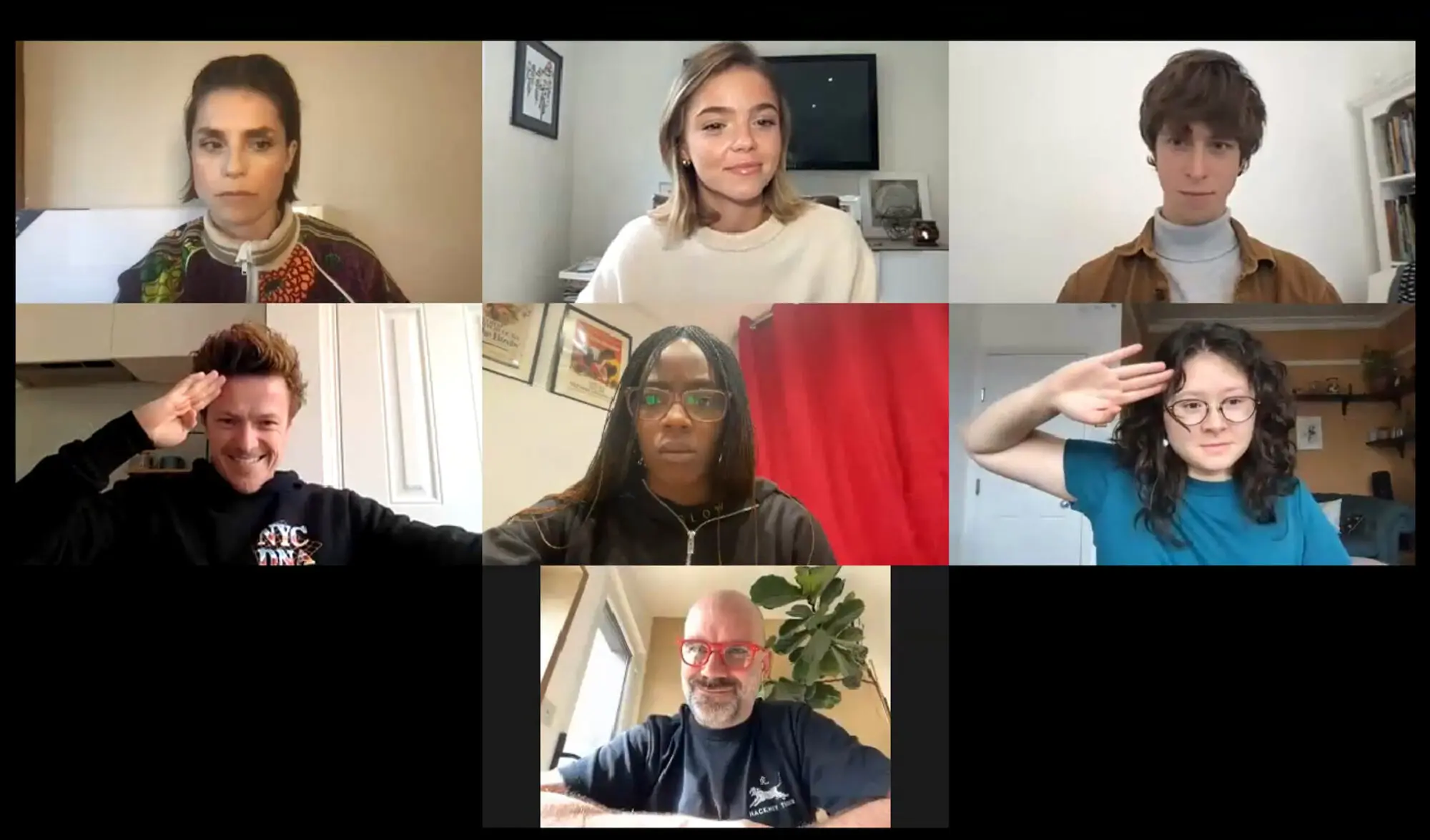 A screenshot of a an online video call with seven faces on screen.