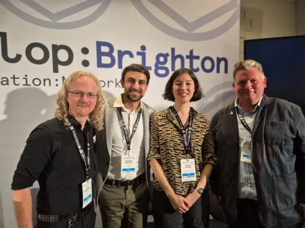 Three men and a woman stood in front of a board that reads 'Develop:Brighton'.