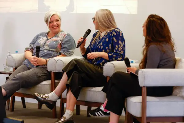 Jackie Sweeney, Blair Barnette and Molly Emma Rowe sat in large grey chairs on stage.