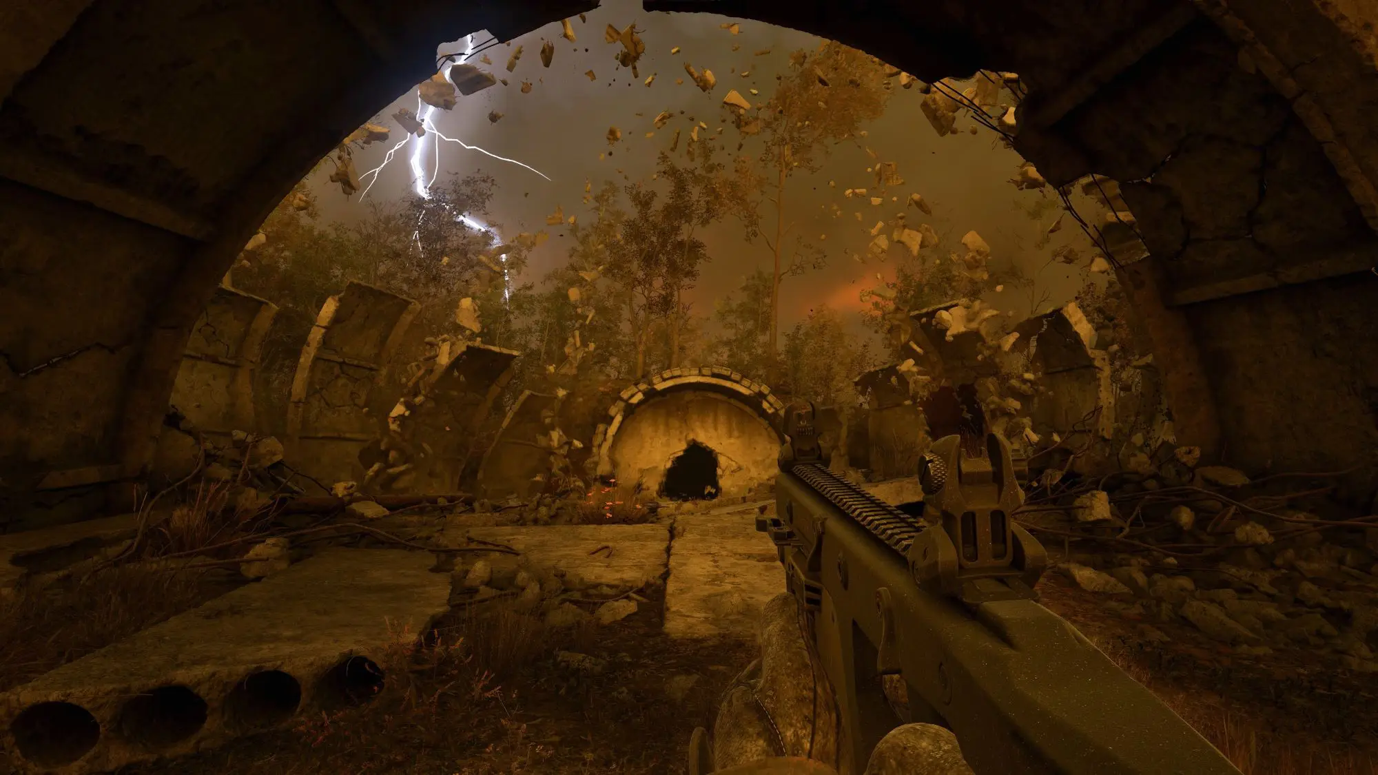 A still from the game S.T.A.L.K.E.R. 2 Heart of Chornobyl. An apocolyptic looking landscape seen from under a domed tunnel like room with debris falling all around.