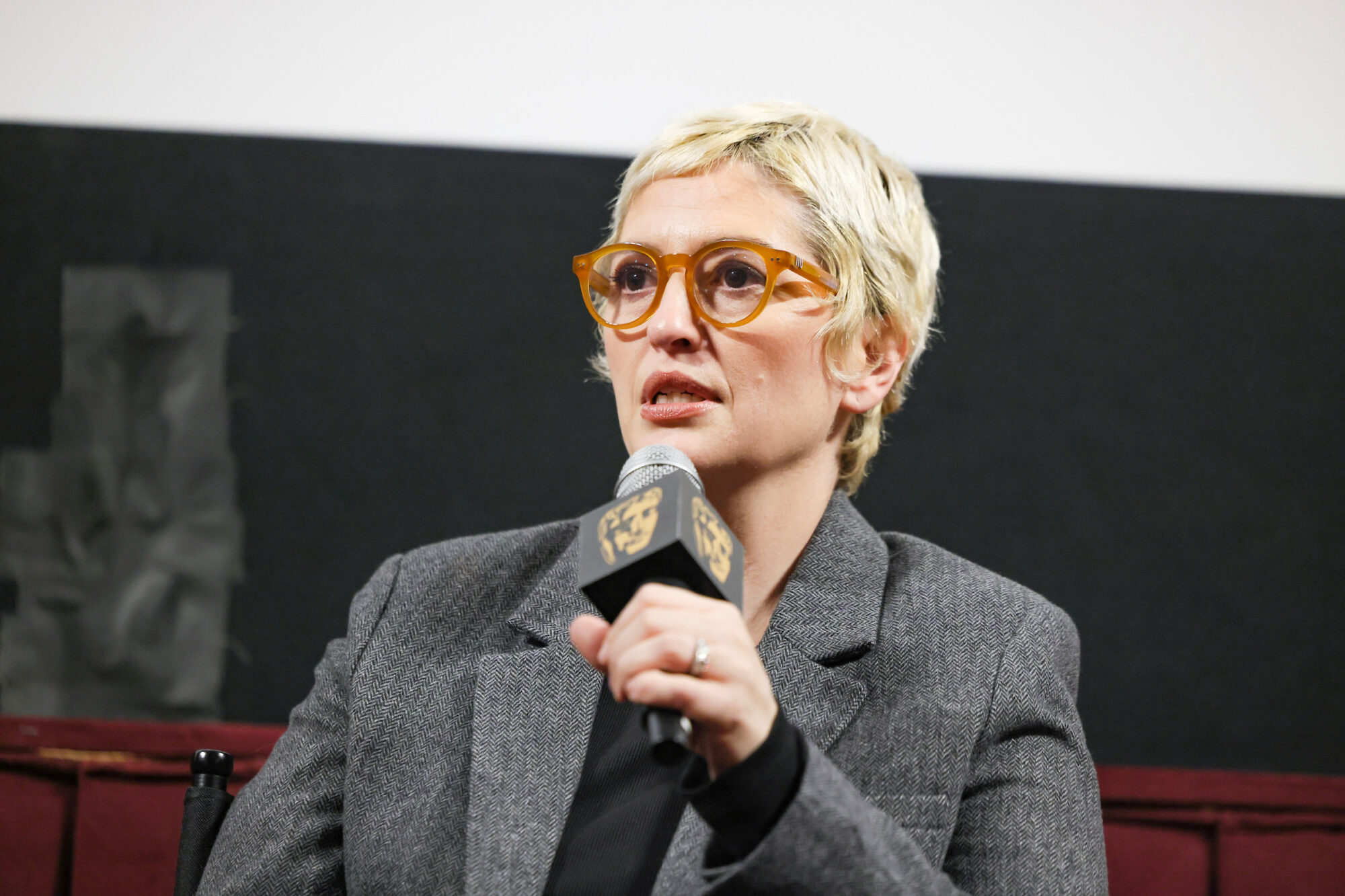 Marielle Heller speaking at a BAFTA event.